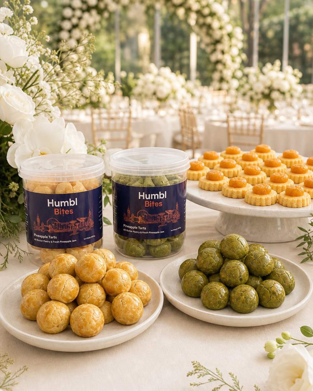 Two jars of Humbi Bites pineapple tarts displayed on a decorated wedding reception table.